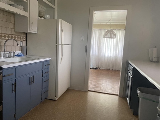 308 S 5th Ave, Streator, IL 61364 - kitchen featuring blue cabinets, open shelves, light countertops, and decorative backsplash