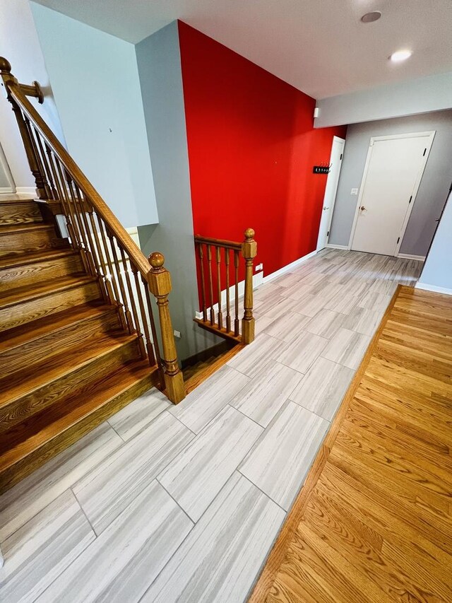 189 Ambleside Rd, Des Plaines, IL 60016 - stairway with an accent wall, wood finish floors, and recessed lighting