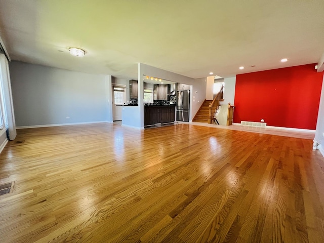 189 Ambleside Rd, Des Plaines, IL 60016 - unfurnished living room with light wood-style floors, stairway, recessed lighting, and plenty of natural light