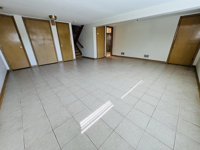 189 Ambleside Rd, Des Plaines, IL 60016 - empty room with stairway and light tile patterned flooring