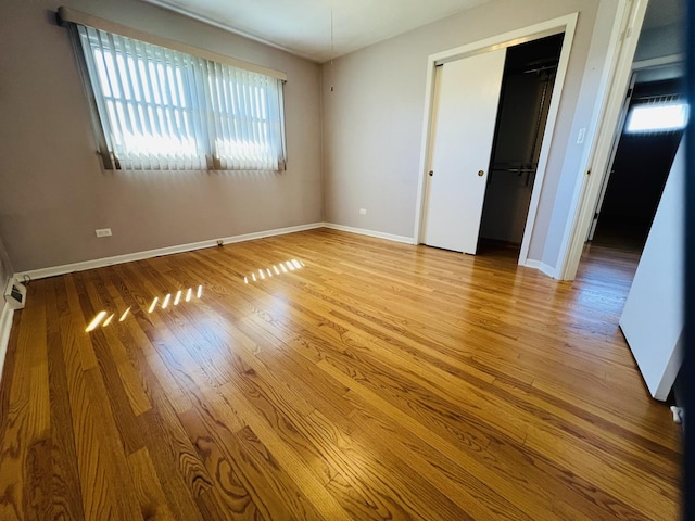 189 Ambleside Rd, Des Plaines, IL 60016 - unfurnished bedroom with wood finished floors and a closet