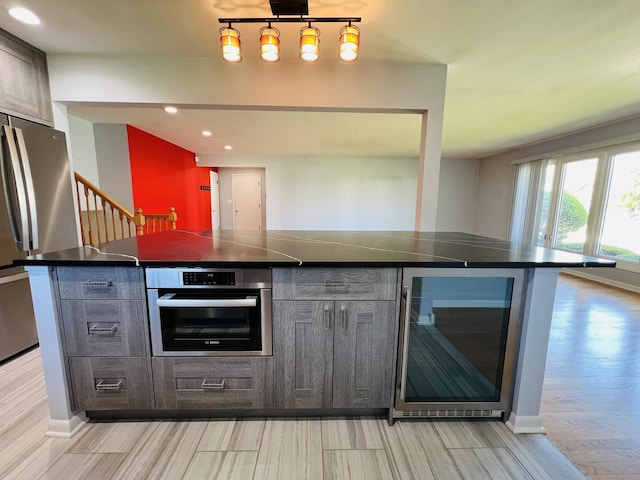 189 Ambleside Rd, Des Plaines, IL 60016 - kitchen featuring stainless steel appliances, wine cooler, dark countertops, light wood finished floors, and recessed lighting