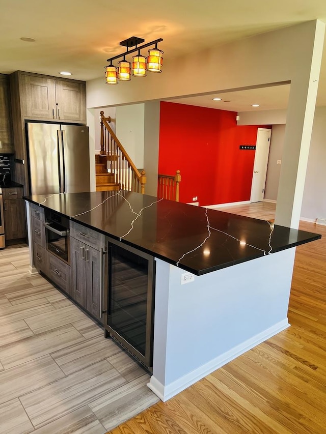 189 Ambleside Rd, Des Plaines, IL 60016 - kitchen with wine cooler, freestanding refrigerator, dark countertops, light wood-type flooring, and recessed lighting