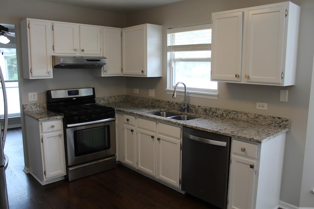 1098 Clover Hill Ln, Elgin, IL 60120 - kitchen with appliances with stainless steel finishes, under cabinet range hood, dark wood-style flooring, and white cabinets