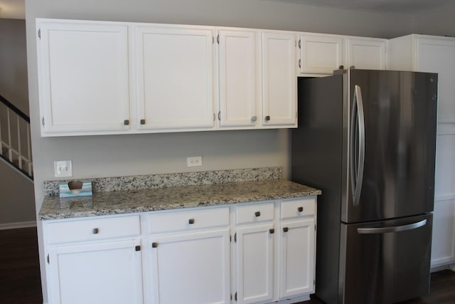 1098 Clover Hill Ln, Elgin, IL 60120 - kitchen with freestanding refrigerator, white cabinetry, light stone countertops, and dark wood-style floors