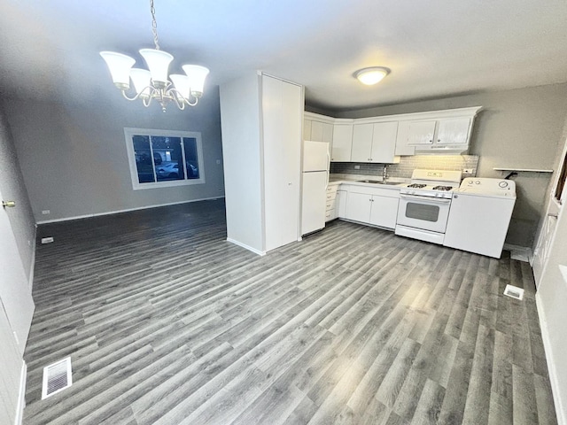 1034 E Tulip Way, Palatine, IL 60074 - kitchen with white appliances, washer / clothes dryer, under cabinet range hood, a chandelier, and backsplash