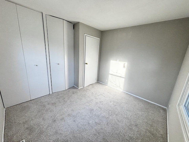 1034 E Tulip Way, Palatine, IL 60074 - unfurnished bedroom featuring carpet floors and two closets