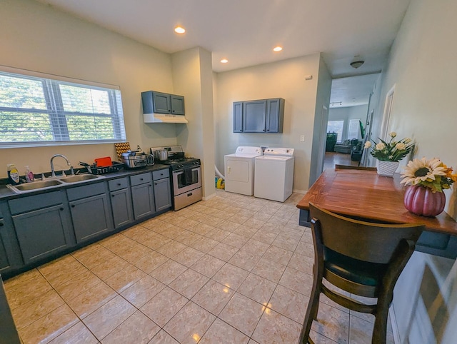 104 W 112th Pl, Chicago, IL 60628 - kitchen with stainless steel gas range oven, independent washer and dryer, light tile patterned flooring, recessed lighting, and dark countertops