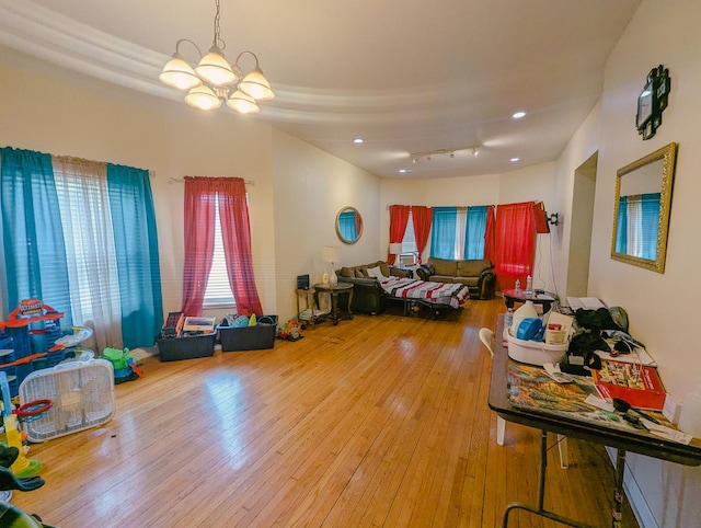 104 W 112th Pl, Chicago, IL 60628 - bedroom with multiple windows, hardwood / wood-style floors, and a chandelier