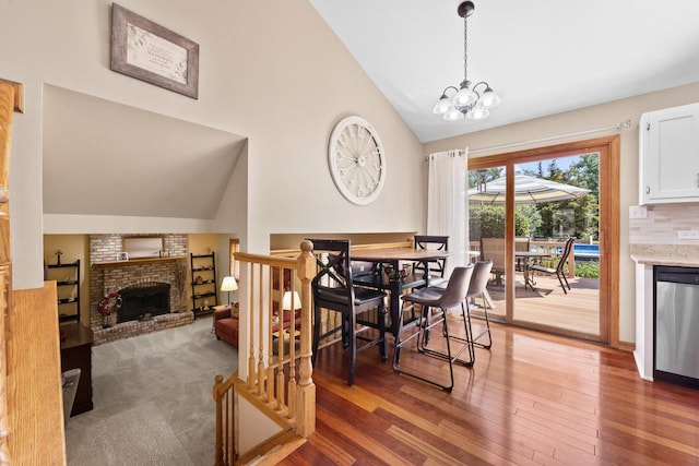 17019 Danielle Ct, Oak Forest, IL 60452 - dining space featuring wood finished floors, a fireplace, high vaulted ceiling, and a chandelier
