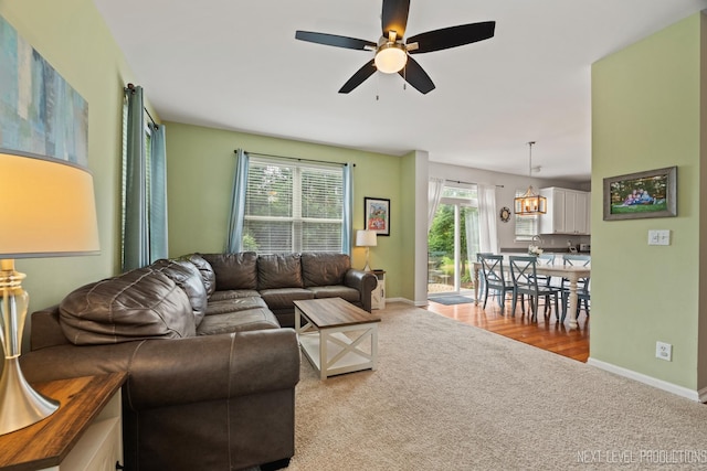 1211 Hall St, Sugar Grove, IL 60554 - carpeted living room featuring a ceiling fan and a chandelier