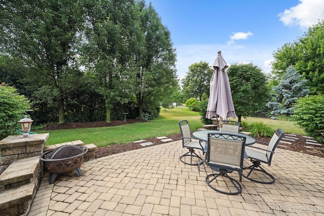 1211 Hall St, Sugar Grove, IL 60554 - view of patio with an outdoor fire pit, outdoor dining area, and view of wooded area