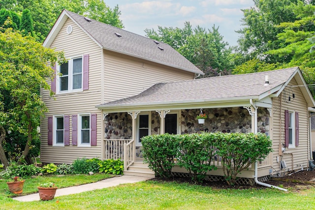 620 Elm St, Maple Park, IL 60151 - traditional-style home featuring a porch, stone siding, a front lawn, and a shingled roof
