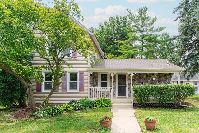 620 Elm St, Maple Park, IL 60151 - view of front facade featuring covered porch, a front lawn, and stone siding