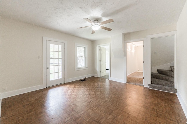 620 Elm St, Maple Park, IL 60151 - unfurnished living room with a ceiling fan, stairway, and a textured ceiling