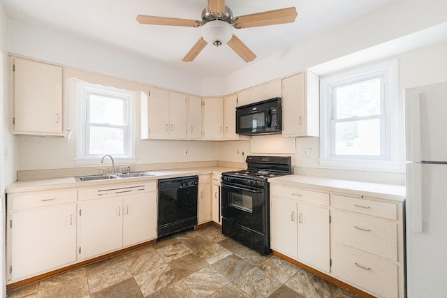 620 Elm St, Maple Park, IL 60151 - kitchen with black appliances, light countertops, stone finish flooring, and cream cabinetry