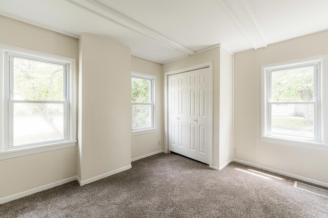 620 Elm St, Maple Park, IL 60151 - unfurnished bedroom with carpet, beam ceiling, and a closet
