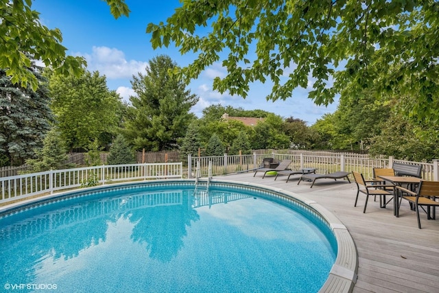 732 Green Castle Ct, West Dundee, IL 60118 - view of swimming pool with a fenced backyard, a deck, and view of scattered trees