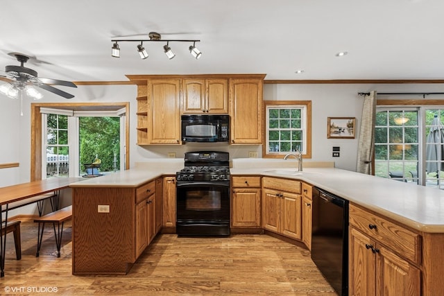 732 Green Castle Ct, West Dundee, IL 60118 - kitchen with black appliances, a peninsula, light countertops, ceiling fan, and light wood-type flooring