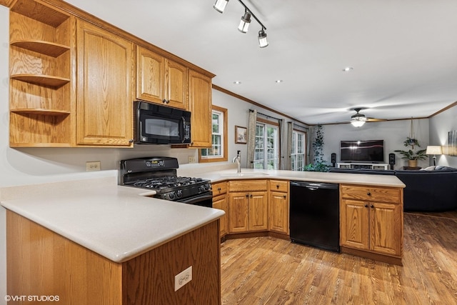 732 Green Castle Ct, West Dundee, IL 60118 - kitchen featuring black appliances, a peninsula, open floor plan, light countertops, and light wood finished floors
