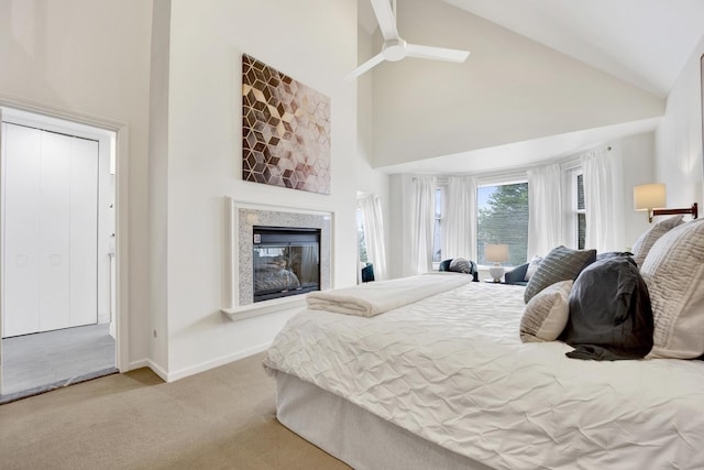 826 S Bell Ave, Chicago, IL 60612 - carpeted bedroom with high vaulted ceiling, a glass covered fireplace, and ceiling fan