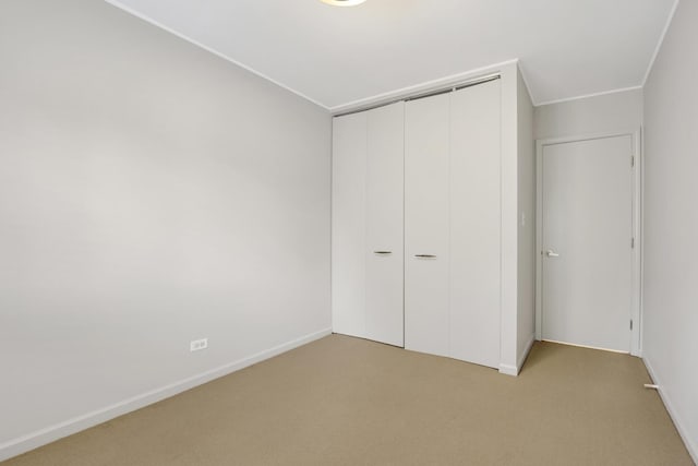 826 S Bell Ave, Chicago, IL 60612 - unfurnished bedroom featuring light carpet and a closet