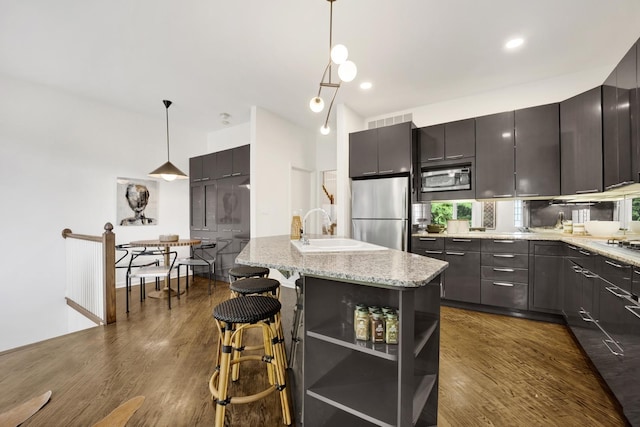 826 S Bell Ave, Chicago, IL 60612 - kitchen with stainless steel appliances, dark wood finished floors, open shelves, a kitchen island, and a breakfast bar area
