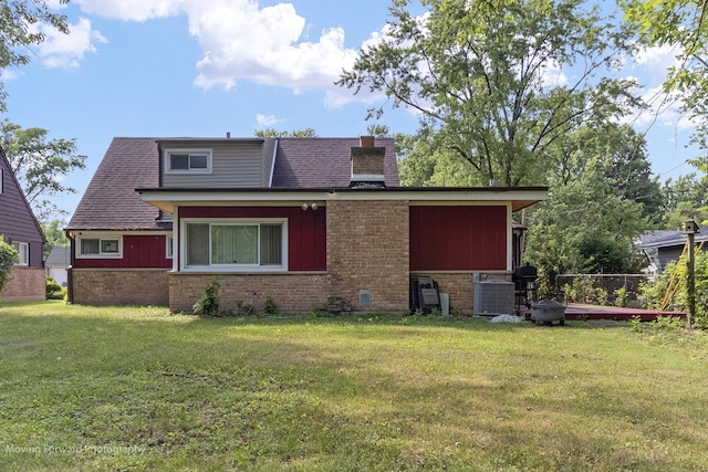 109 Walnut St, Park Forest, IL 60466 - back of house featuring brick siding, a chimney, and a lawn