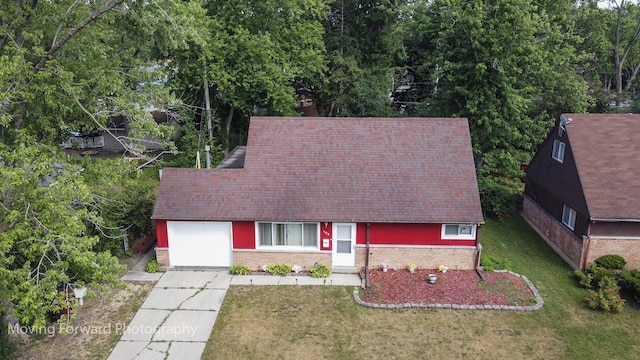 109 Walnut St, Park Forest, IL 60466 - view of front of home with an attached garage, concrete driveway, a front yard, and brick siding