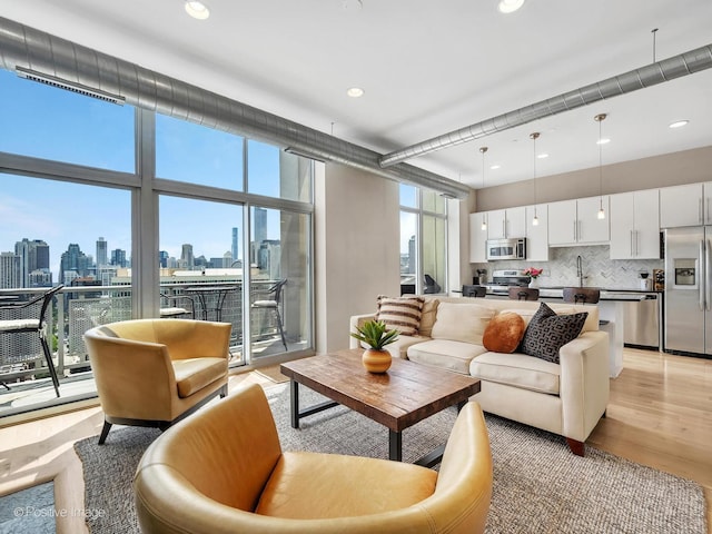 700 N Larrabee St Unit 2008, Chicago, IL 60654 - living room featuring a skyline view, light wood-style floors, expansive windows, and recessed lighting