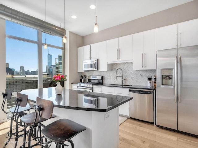 700 N Larrabee St Unit 2008, Chicago, IL 60654 - kitchen with appliances with stainless steel finishes, a view of skyline, dark countertops, backsplash, and recessed lighting