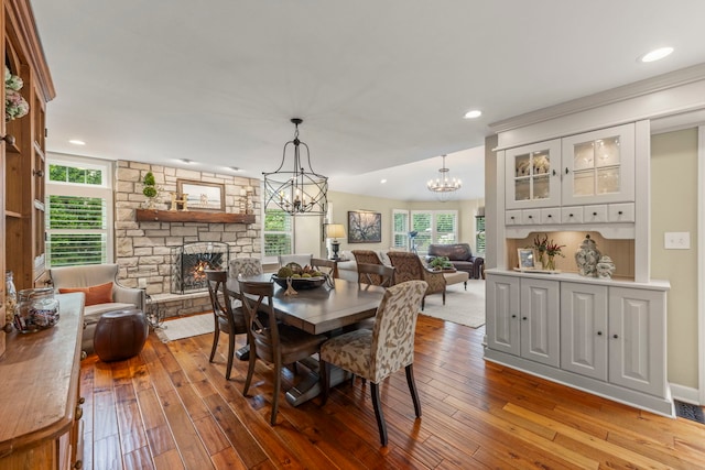 1563 Abbotsford Dr, Naperville, IL 60563 - dining area with a chandelier, a fireplace, hardwood / wood-style floors, and recessed lighting