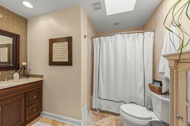 1563 Abbotsford Dr, Naperville, IL 60563 - full bathroom with a skylight, vanity, shower / bath combo, and stone finish floors