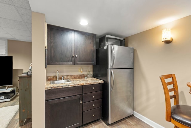 1563 Abbotsford Dr, Naperville, IL 60563 - kitchen with freestanding refrigerator, light wood finished floors, dark brown cabinets, and light stone countertops