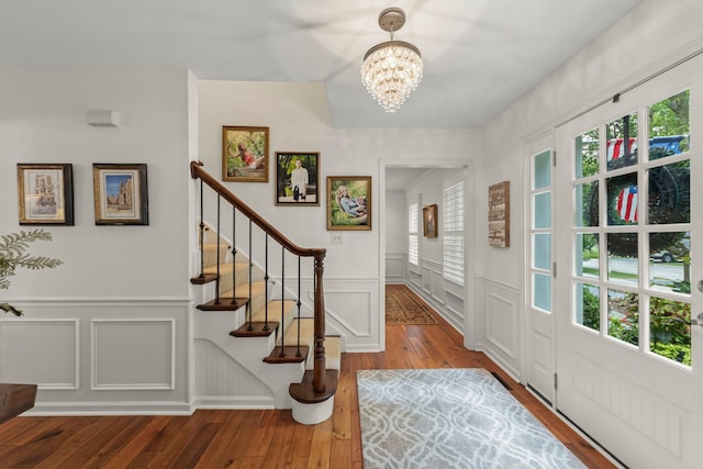 1563 Abbotsford Dr, Naperville, IL 60563 - entryway with a decorative wall, hardwood / wood-style floors, a chandelier, stairs, and wainscoting