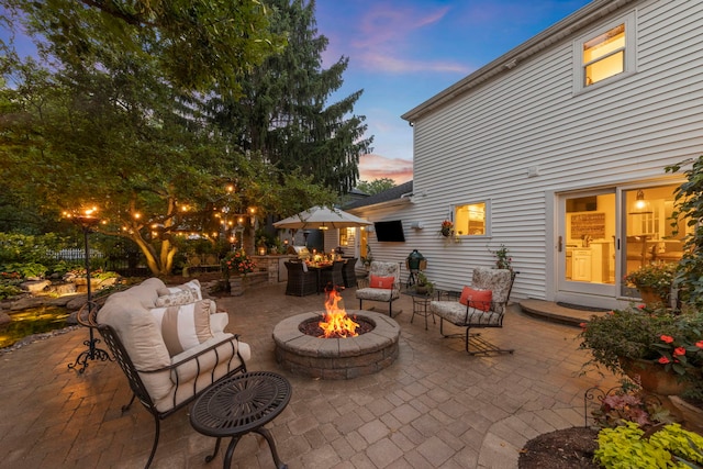 1563 Abbotsford Dr, Naperville, IL 60563 - patio terrace at dusk featuring a patio area and an outdoor living space with a fire pit