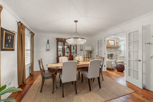 1563 Abbotsford Dr, Naperville, IL 60563 - dining space with ornamental molding, a chandelier, plenty of natural light, and wood-type flooring