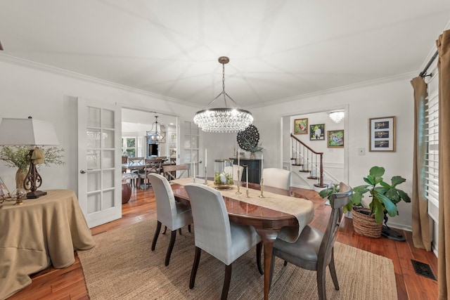 1563 Abbotsford Dr, Naperville, IL 60563 - dining area with ornamental molding, a chandelier, light wood-style flooring, and stairway