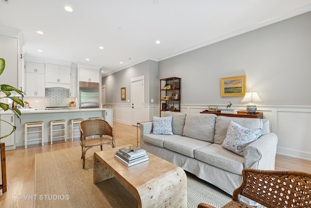 4321 N Paulina St Unit 2N, Chicago, IL 60613 - living area featuring recessed lighting, light wood-style floors, crown molding, a wainscoted wall, and a decorative wall