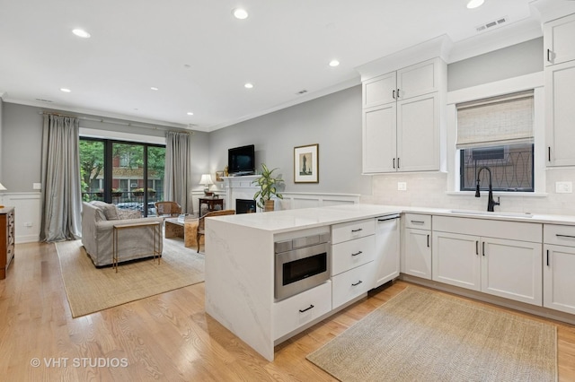 4321 N Paulina St Unit 2N, Chicago, IL 60613 - kitchen with crown molding, dishwasher, open floor plan, a peninsula, and light countertops