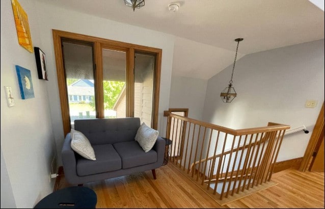 2 Spinnaker Ct, Third Lake, IL 60030 - living area featuring an upstairs landing, wood finished floors, and vaulted ceiling