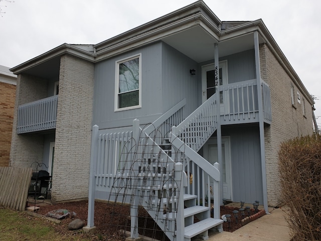 view of side of property with stairway