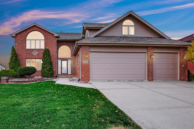 21222 Vivienne Dr, Matteson, IL 60443 - traditional home featuring a garage, driveway, brick siding, a front lawn, and roof with shingles
