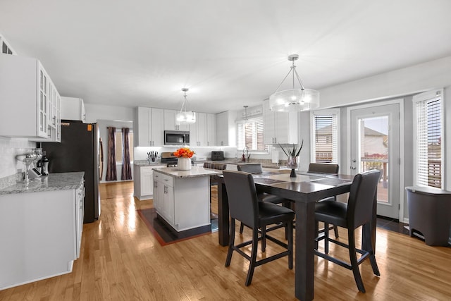 21222 Vivienne Dr, Matteson, IL 60443 - dining area featuring light wood-style floors and a chandelier