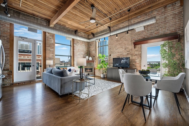 1801 S Michigan Ave Unit 507, Chicago, IL 60616 - living room featuring wood ceiling, brick wall, healthy amount of natural light, wood finished floors, and track lighting