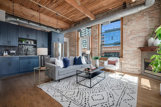 1801 S Michigan Ave Unit 507, Chicago, IL 60616 - living area with brick wall, a wood ceiling with exposed beams, wet bar, wood finished floors, and track lighting