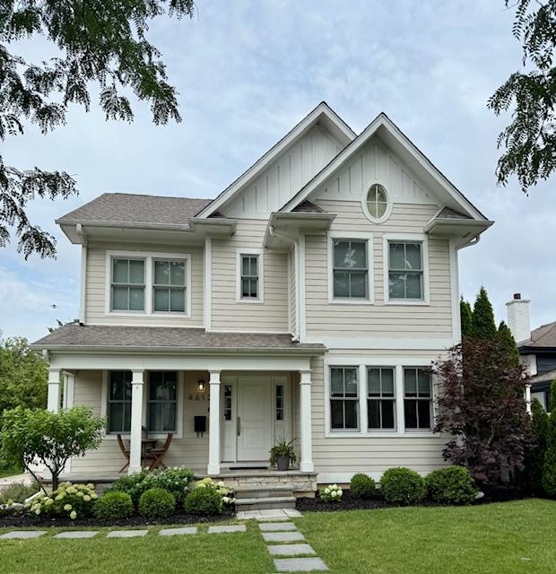 4612 Franklin Ave, Western Springs, IL 60558 - view of front of house featuring a front yard, board and batten siding, a porch, and a shingled roof