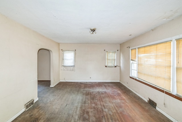 907 W Beardsley Ave, Champaign, IL 61821 - empty room with wood finished floors and arched walkways
