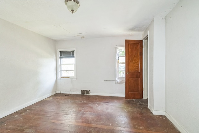 907 W Beardsley Ave, Champaign, IL 61821 - spare room featuring baseboards and wood-type flooring
