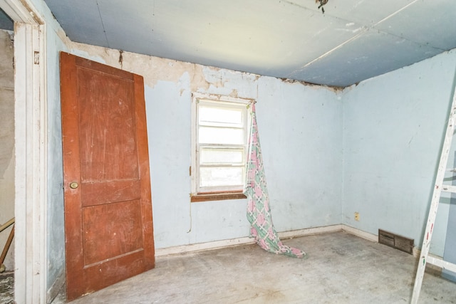 907 W Beardsley Ave, Champaign, IL 61821 - empty room with unfinished concrete flooring